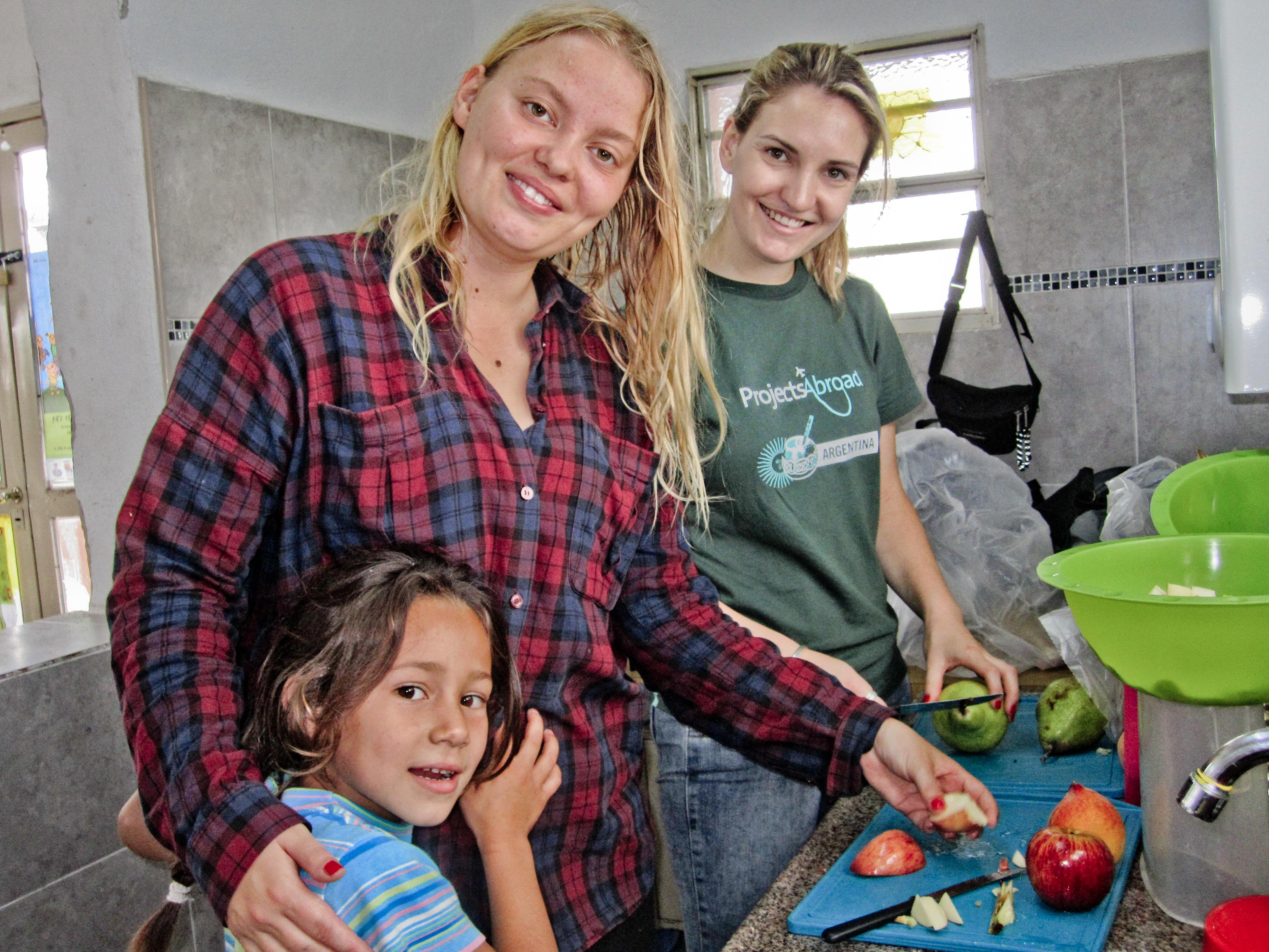 Two Projects Abroad volunteers prepare a snack for the children they work with at our Childcare Project in Argentina. Projects Abroad volunteer working with children in Argentina prepares fruit in dining halls during a Childcare project.